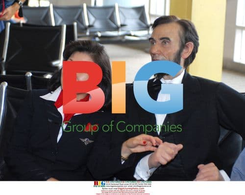 Delta Flight Attendant Sits with Lincoln Wax Figure