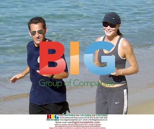 Nicolas and Carla Sarkozy running on beach
