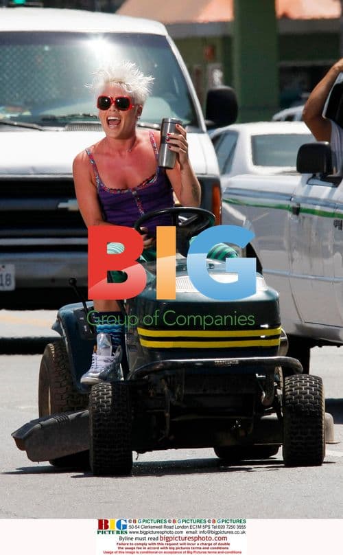 Pink driving lawn mower on Sunset Blvd