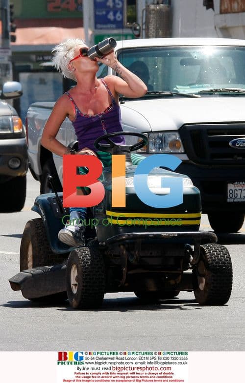 Pink drives lawn mower on Sunset Blvd