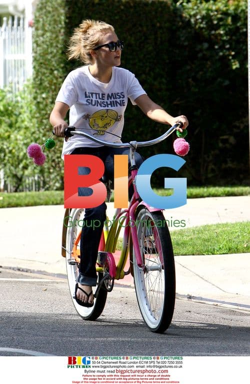 Miley Cyrus and Emily Osment ride bikes