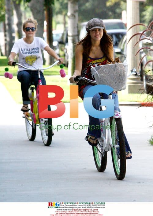 Miley Cyrus and Emily Osment ride bikes