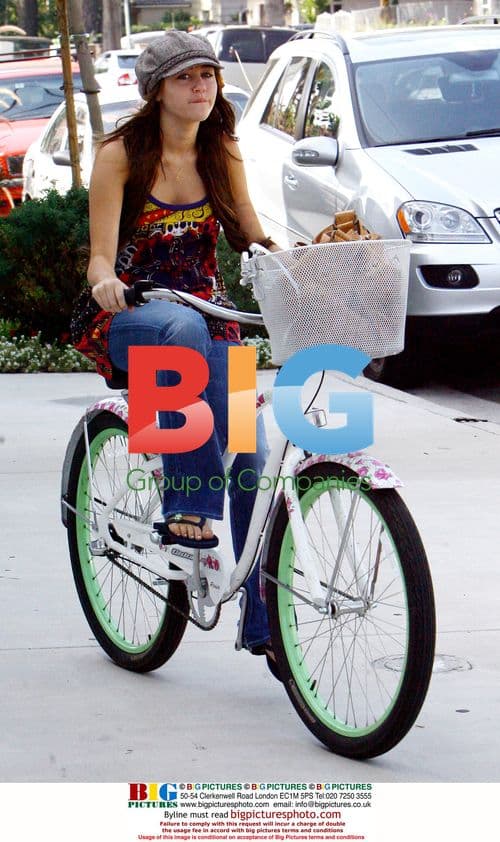 Miley Cyrus and Emily Osment ride bikes