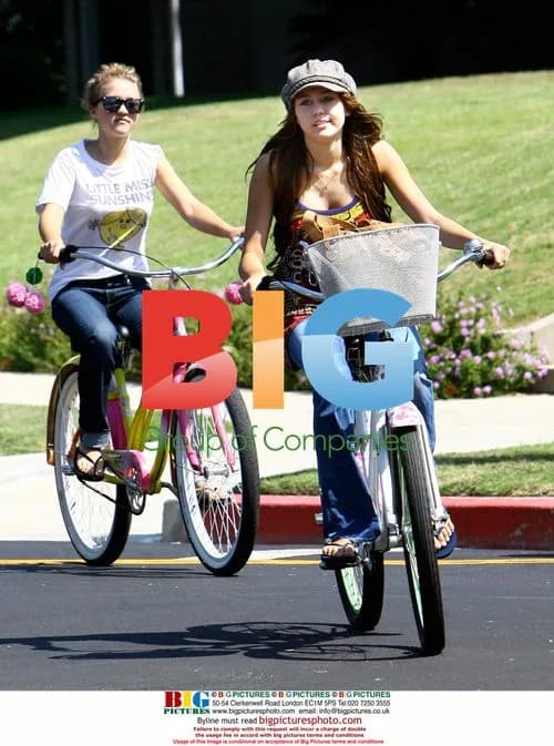 Miley Cyrus and Emily Osment ride bikes