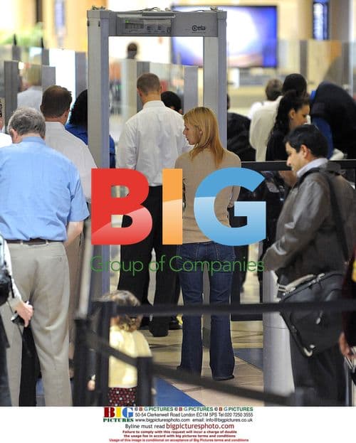 Claire Danes navigates airport with luggage