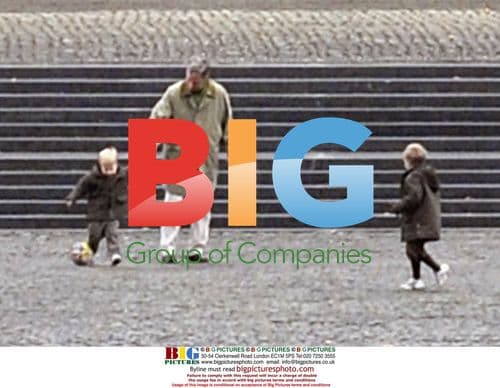 Prince Philippe plays football with children