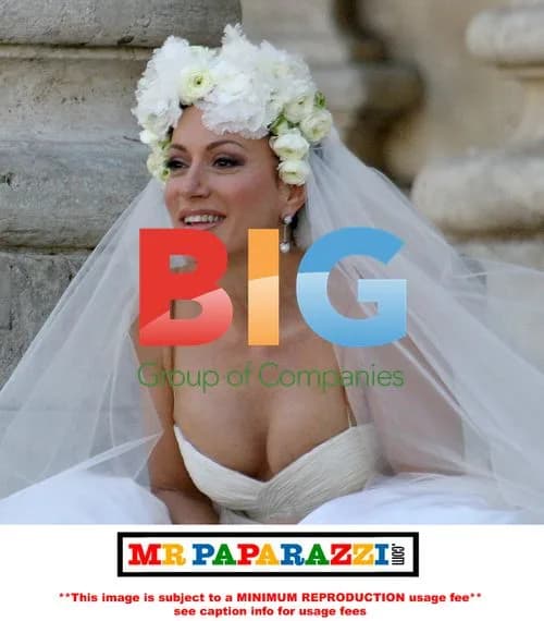 Nancy Dell' Olio Poses in Wedding Dresses