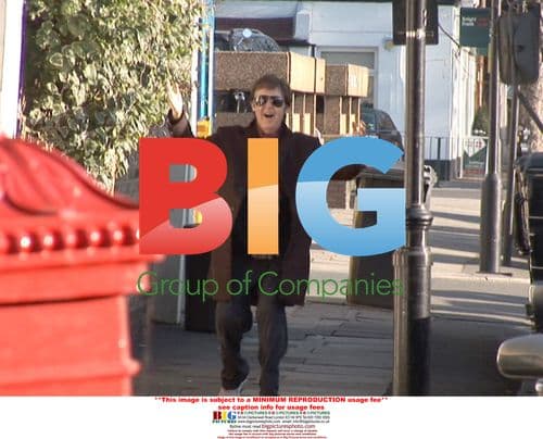 Paul McCartney pushes photographer's camera