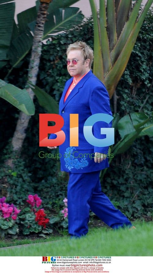 Elton John departs Oscar party in flamboyant outfit