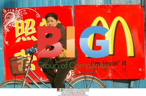 Chinese Woman Cycles Past Beijing McDonald's