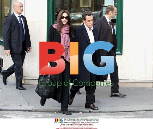 Sarkozy Exits Hotel with Bruni