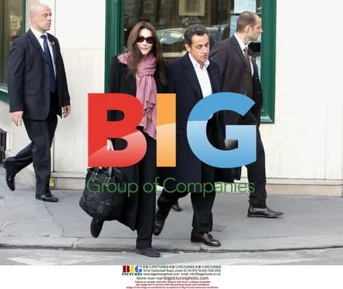 Sarkozy Exits Hotel with Bruni