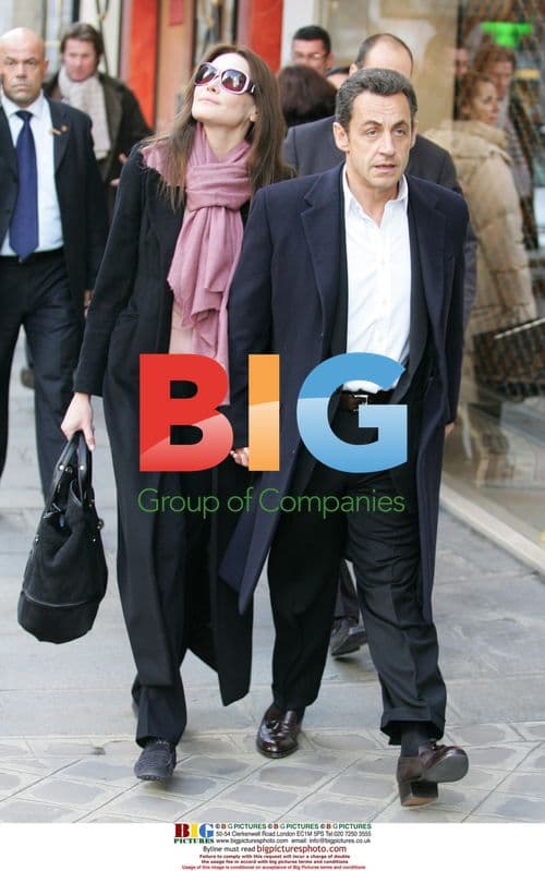 Sarkozy and Bruni Exit Hotel