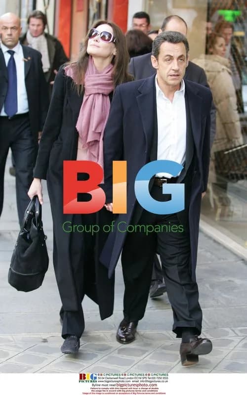 Sarkozy and Bruni Exit Hotel