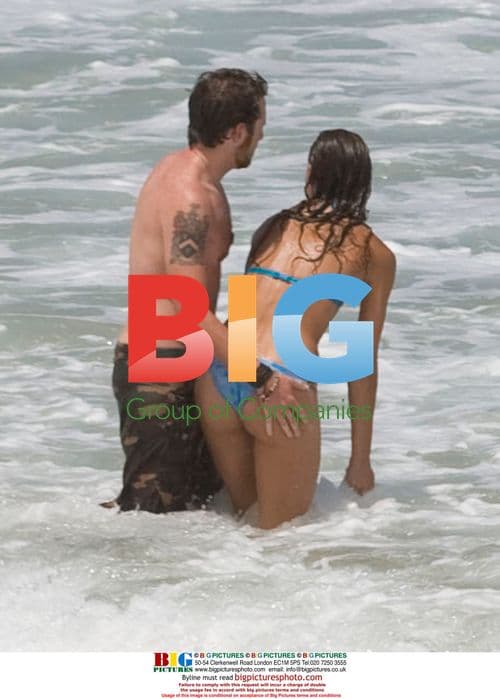 Sharni Vinson and AJ Buckley on beach in Sydney