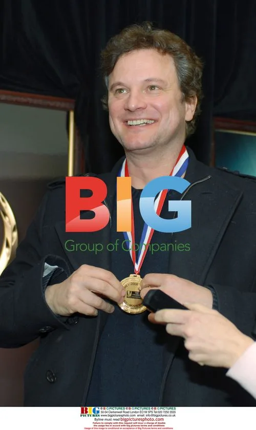 Colin Firth Poses with Medal