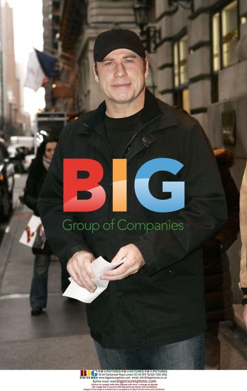 John Travolta exits Midtown hotel