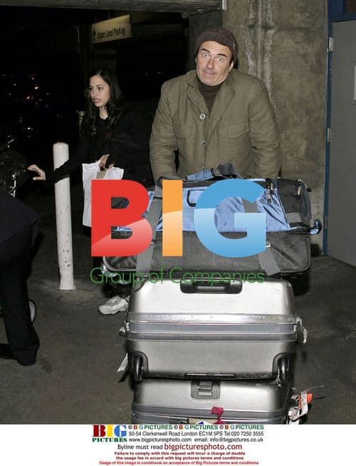 Julian McMahon and female companion arrive at LAX