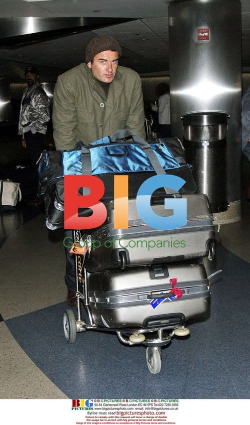 Julian McMahon and companion arrive at LAX