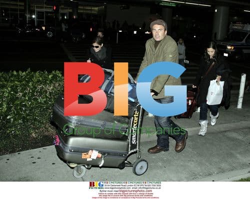 Julian McMahon and Companion Arrive at LAX