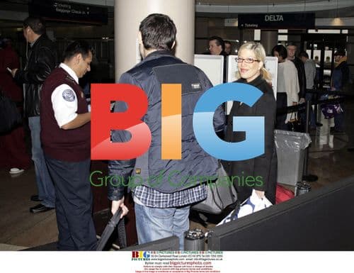 Tori Spelling Departs LAX with Colorful Suitcase