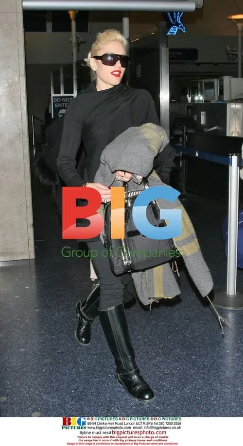 Gwen Stefani covers baby bump at LAX