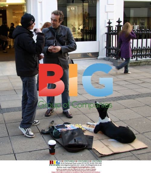 John Hannah signs autograph for Big Issue seller