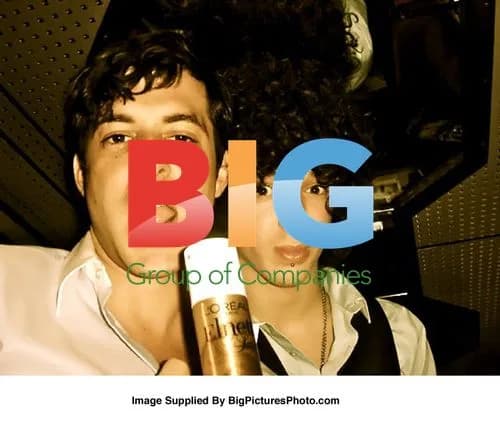Mark Ronson Holds Hairspray with Pal