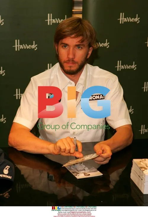 F1 driver Nick Heidfeld signs merchandise