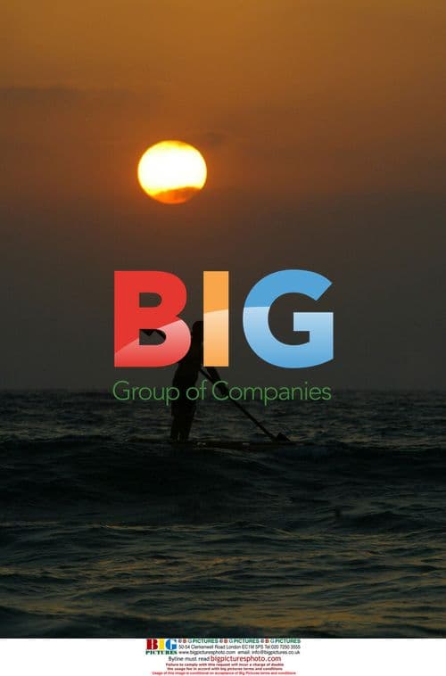 Palestinian fisherman rows boat during sunset in Gaza