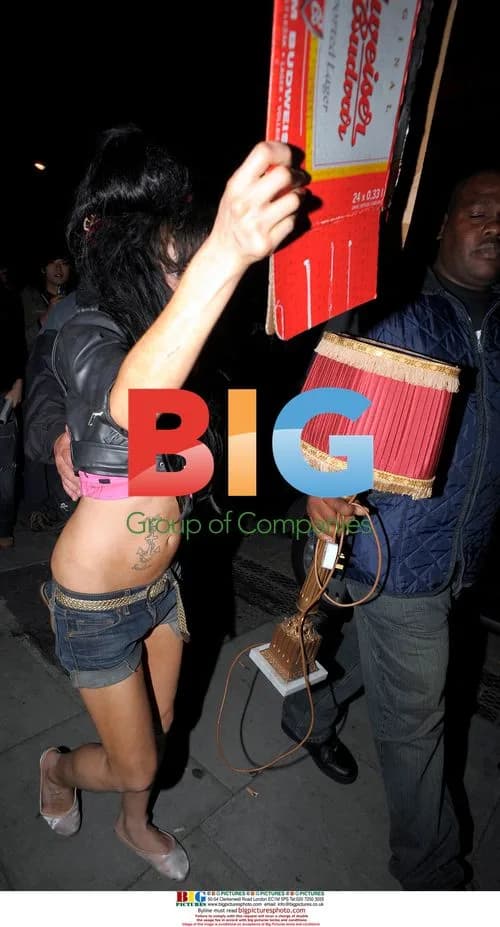 Amy Winehouse Leaves Bar with Lamp