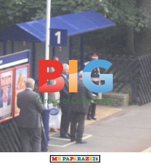 Queen Elizabeth II and Prince Philip Wait at Station