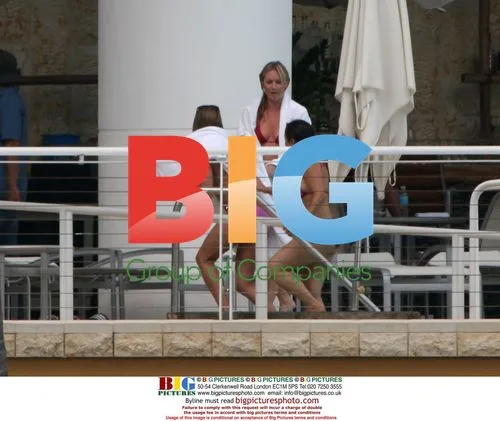 Jennifer Aniston Relaxes by Pool in Miami