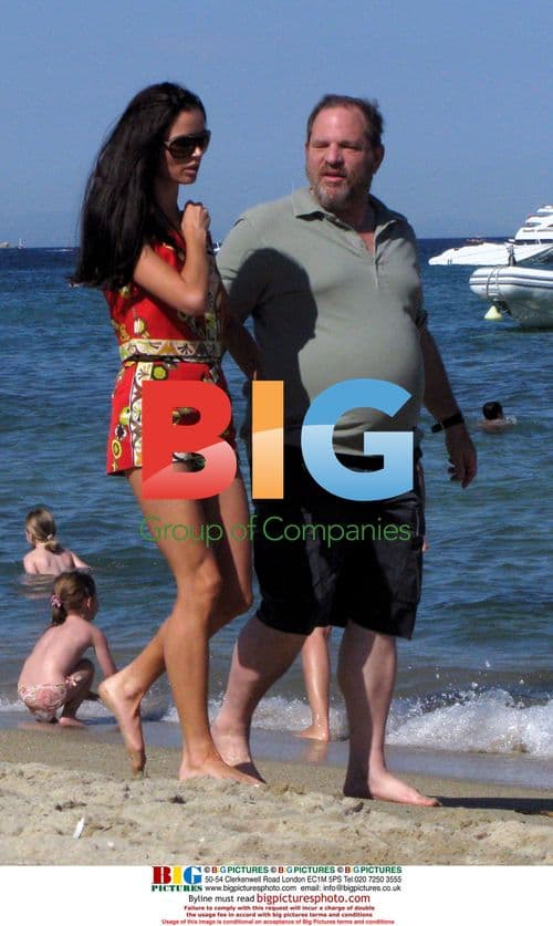 Harvey Weinstein and Georgina Chapman walk on beach in St. Tropez