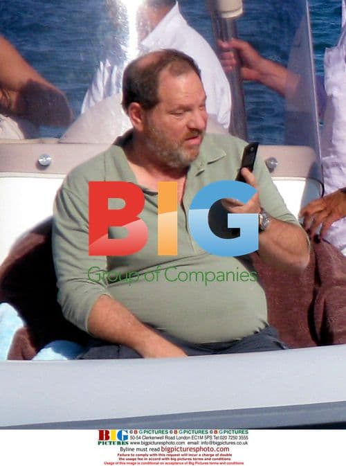 Harvey Weinstein and Georgina Chapman walk on beach in St. Tropez