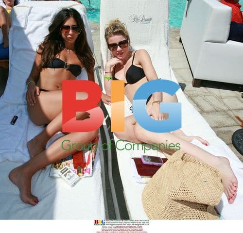 Courtney Semel and Casey Johnson lounge by pool