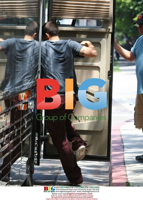 John Mayer flips off paparazzi outside hotel