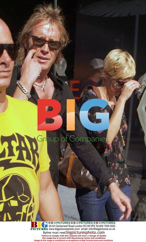 Rhys Ifans and Kimberly Stewart enter hotel