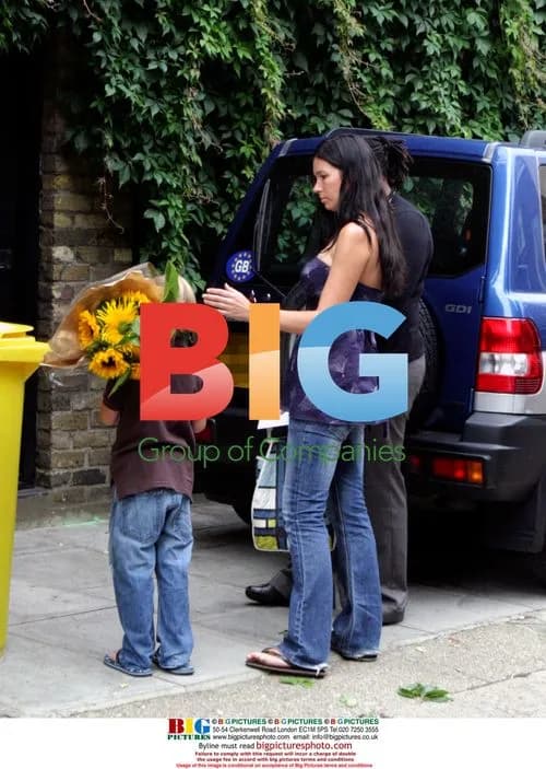 Young visitor presents flowers at Amy Winehouse's home