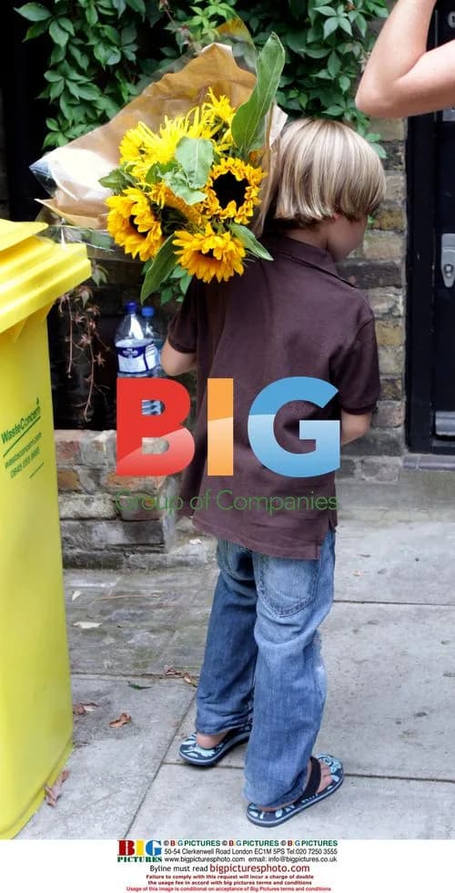 Young Visitor Presents Bouquet Outside Amy Winehouse's Home