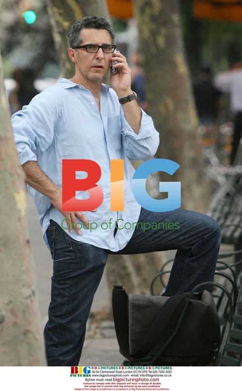 John Turturro on a park bench