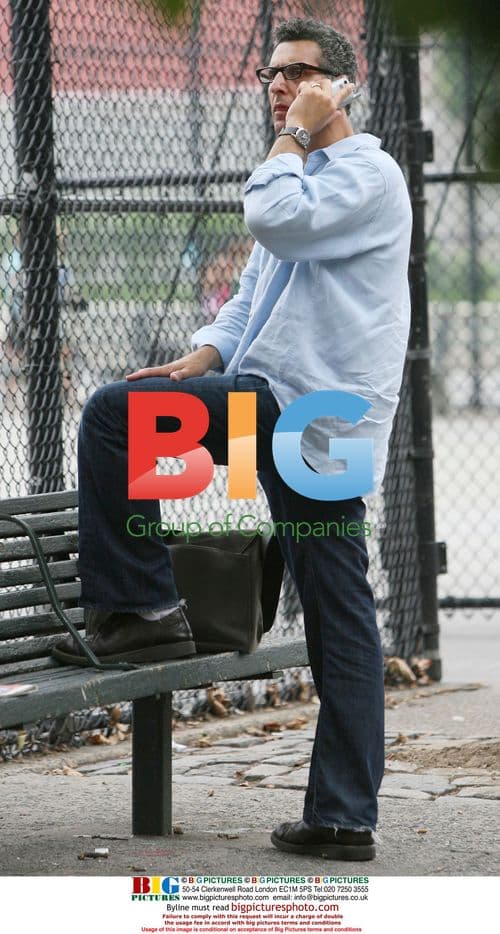 John Turturro talks on cell phone