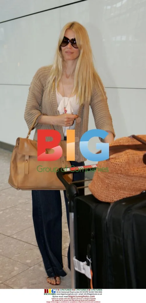 Claudia Schiffer arriving at Heathrow airport