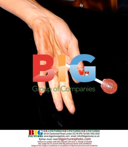 Amy Winehouse talks to paparazzi outside Camden home