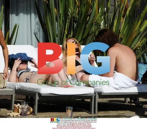 Lindsay Lohan Lounges Poolside