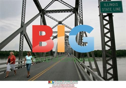 Pedestrians cross flooded bridge in Louisiana, Missouri