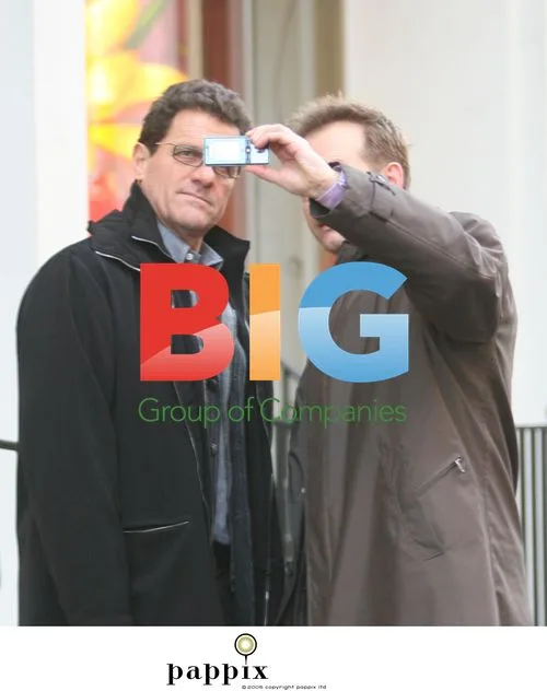 Fabio Capello poses with fan in London