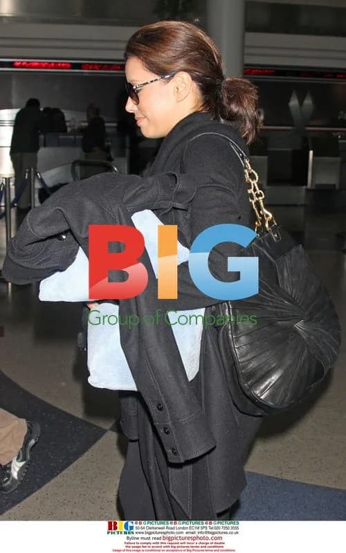 Eva Longoria Departs LAX with Blue Pillow