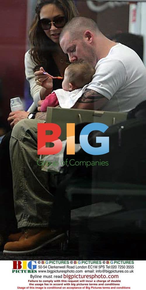 Myleene Klass with partner and baby at Heathrow