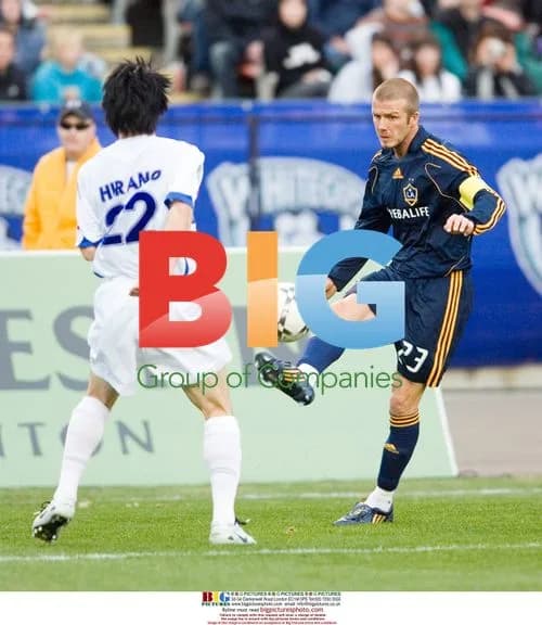 David Beckham kicks ball past Whitecaps player